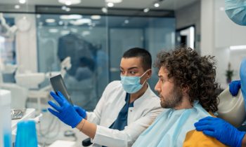 Dentiste qui explique sa chirurgie dentaire à son patient